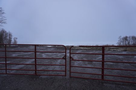 Photographed on a grey cloudy day, a gate prevents residents from entering a remediated site near Lake Nipissing where niobium mine tailings sat for decades.