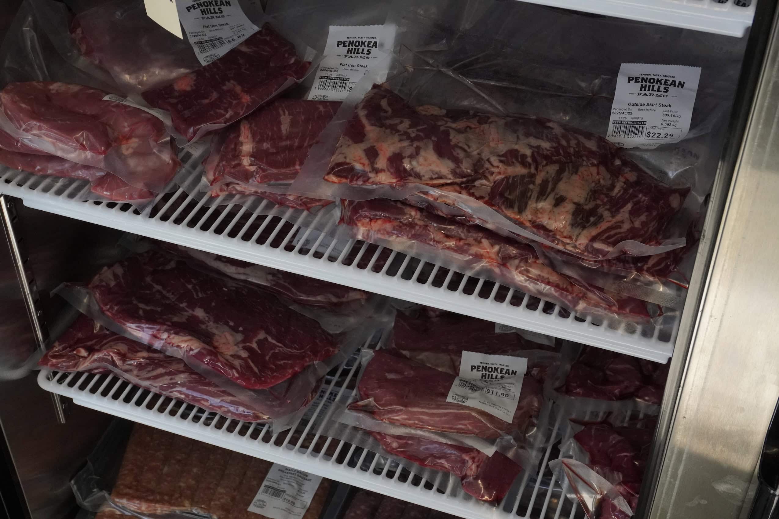 Packaged frozen beef in a freezer.