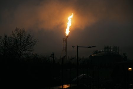 A towering orange flame lights up the night sky at LNG Canada's facility in Kitimat, B.C., Canada
