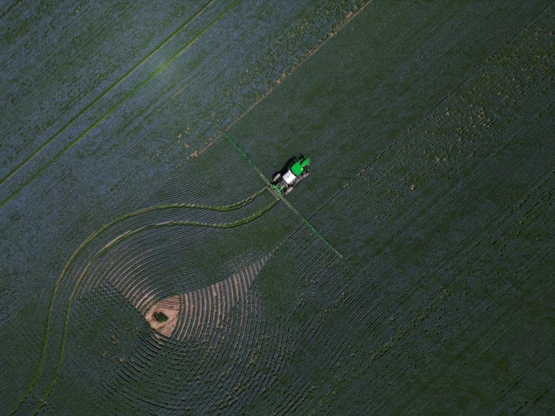 An aerial image of farm equipment in a field in Saskatchewan.