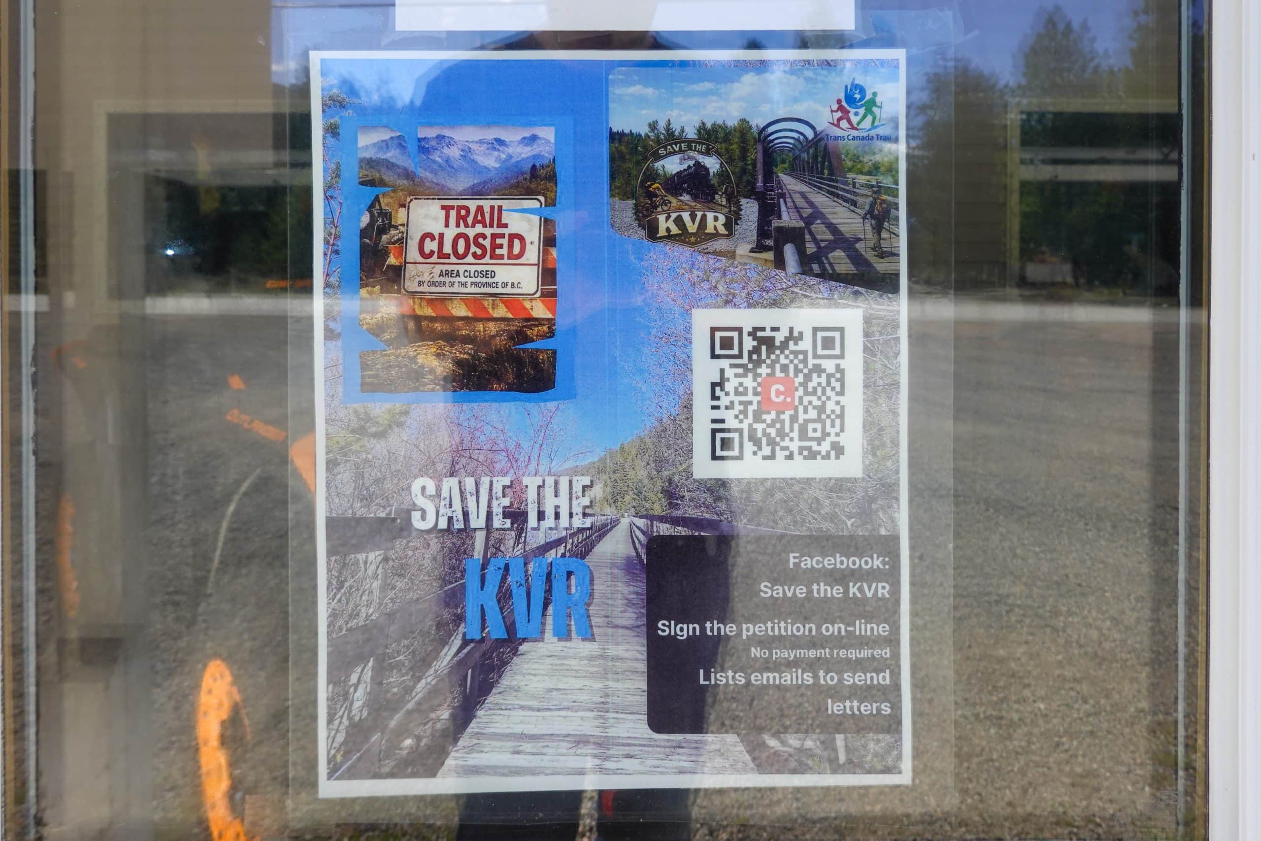 A laminated sign in a shop window reading "Save the KVR."