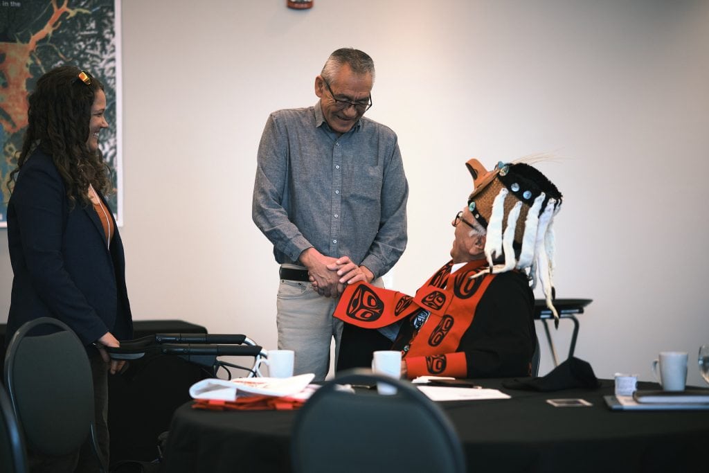 Wet'suwet'en Hereditary Chief Na'moks shakes hands with Gitwilgyoots Chief Algax’m Hax at a salmon summit in Prince Rupert, B.C.