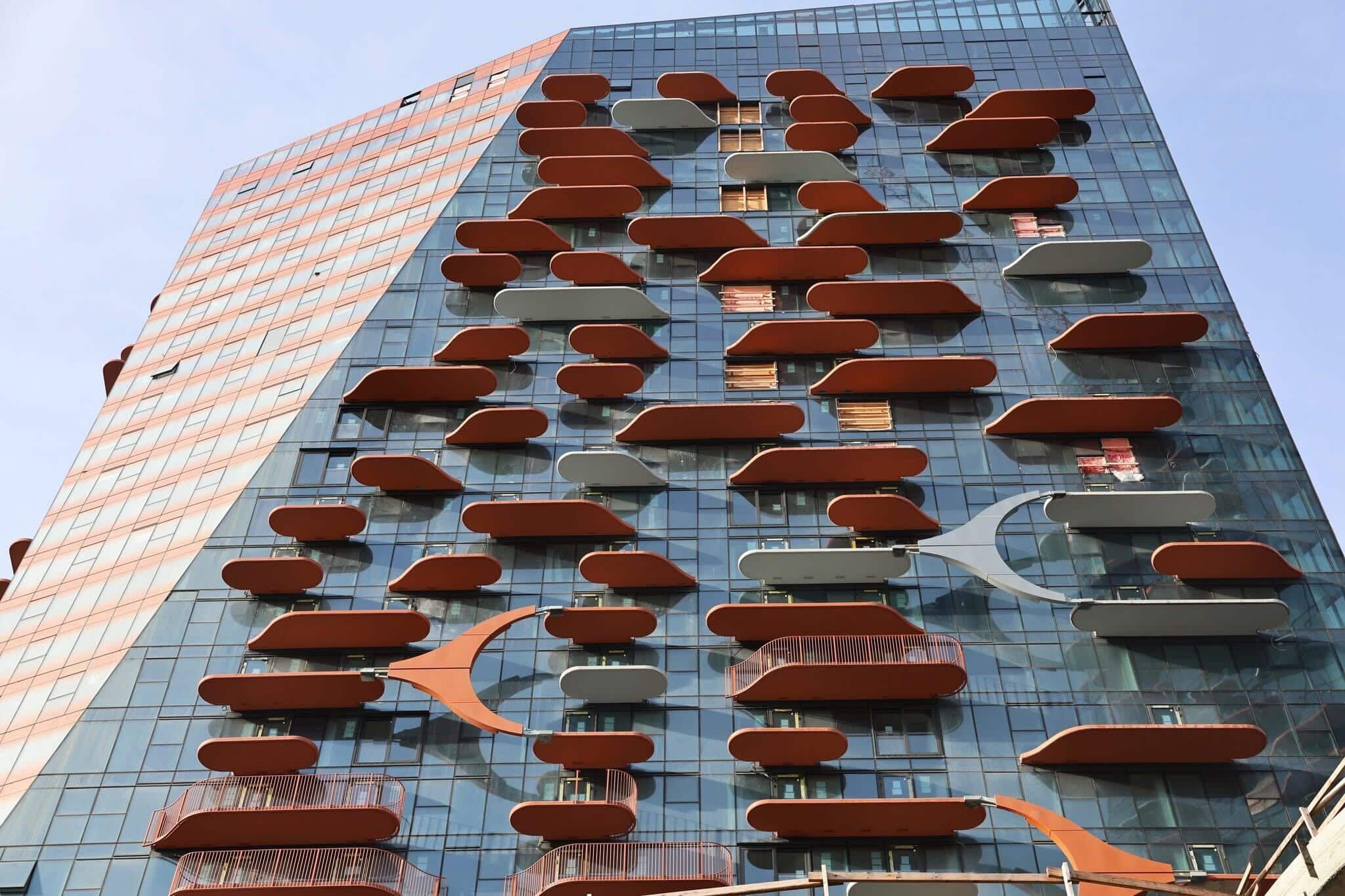 A close up photo of a new building, with orange accents.