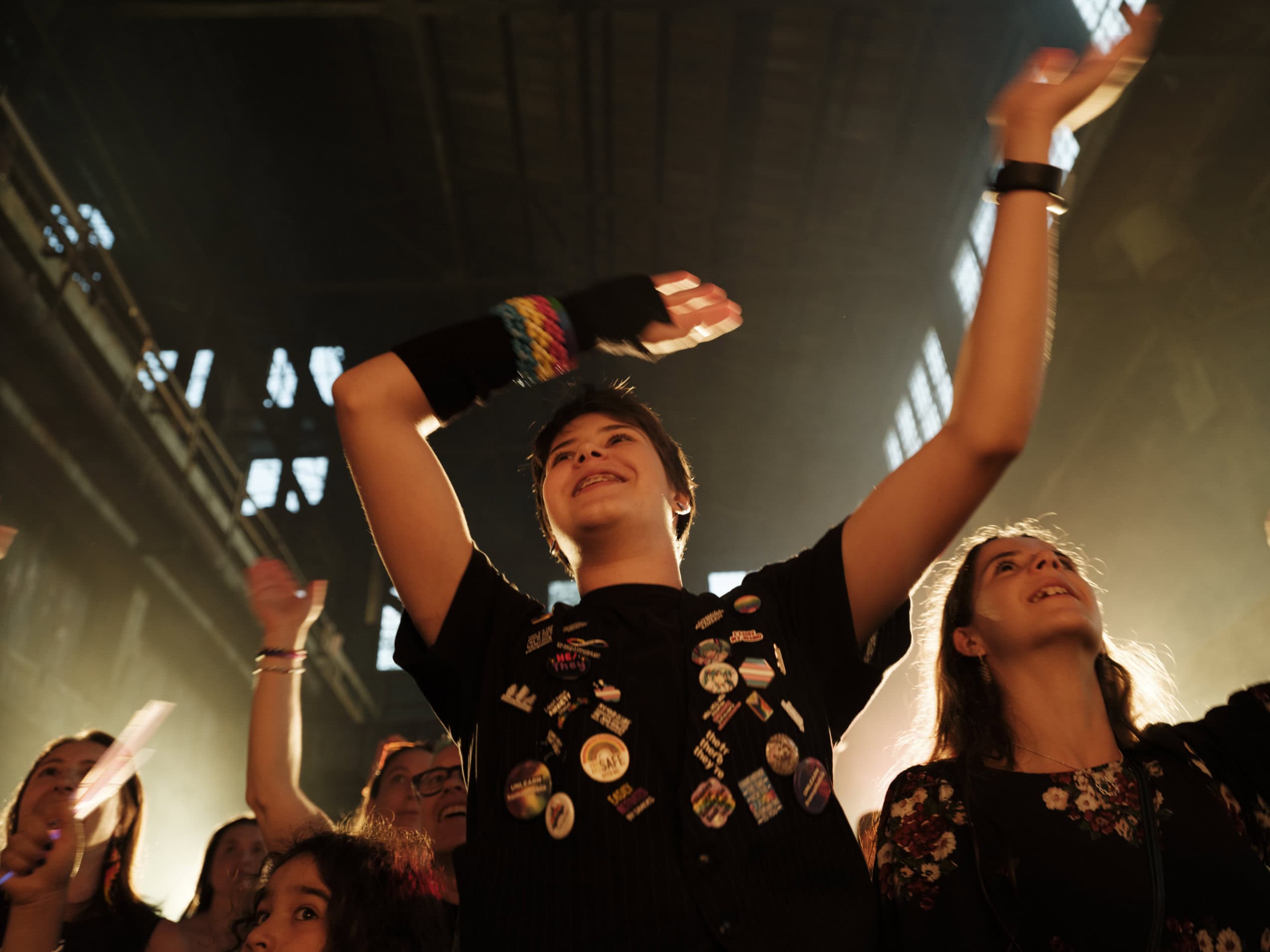 A young person waves their hands in the air during a drag performance at the Britannia Mine Museum in Britannia Beach, B.C.