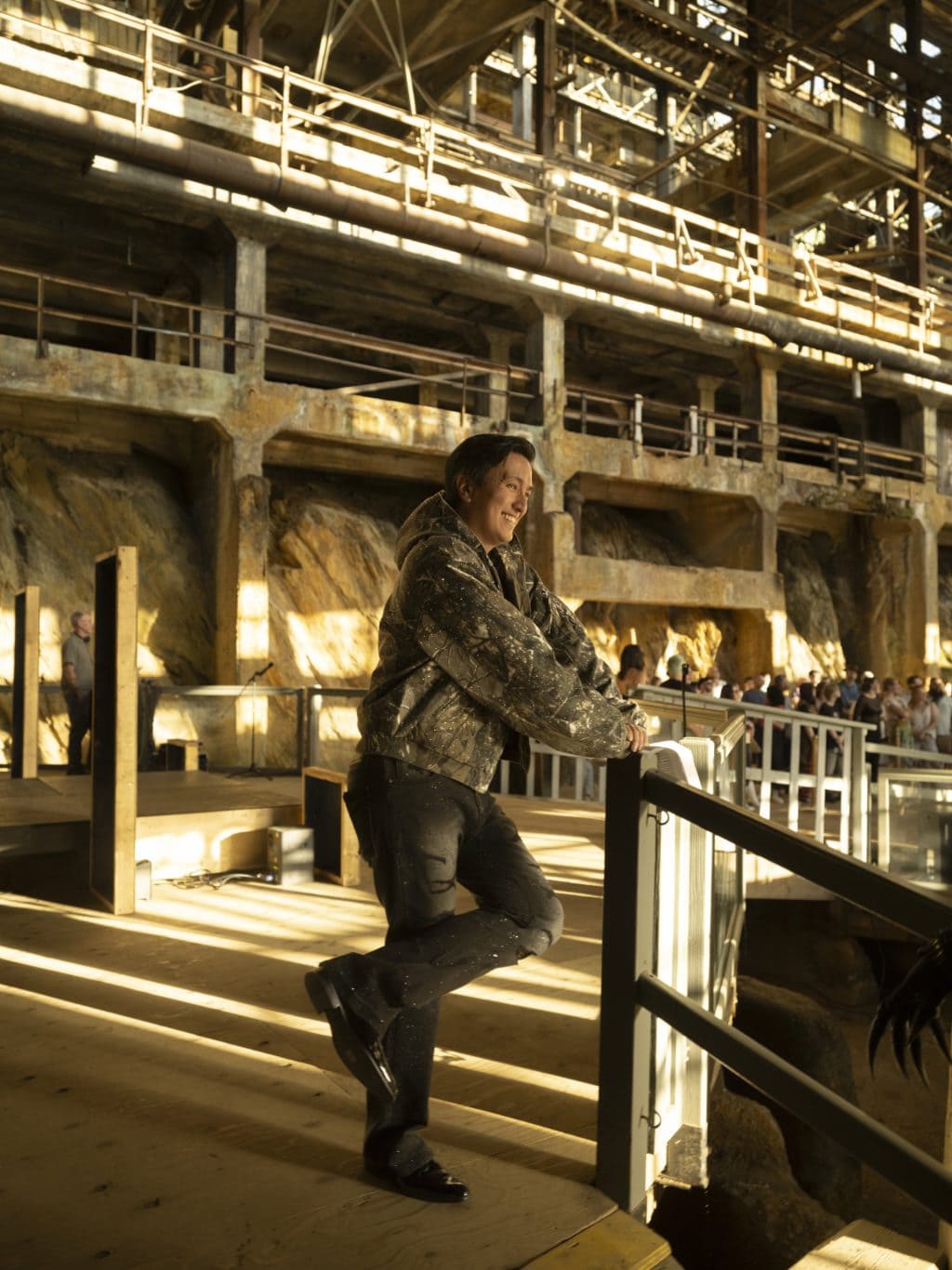 Derek A. Jang, a director at the Britannia Mine Museum, stands and smiles in the former copper mine during a drag performance.