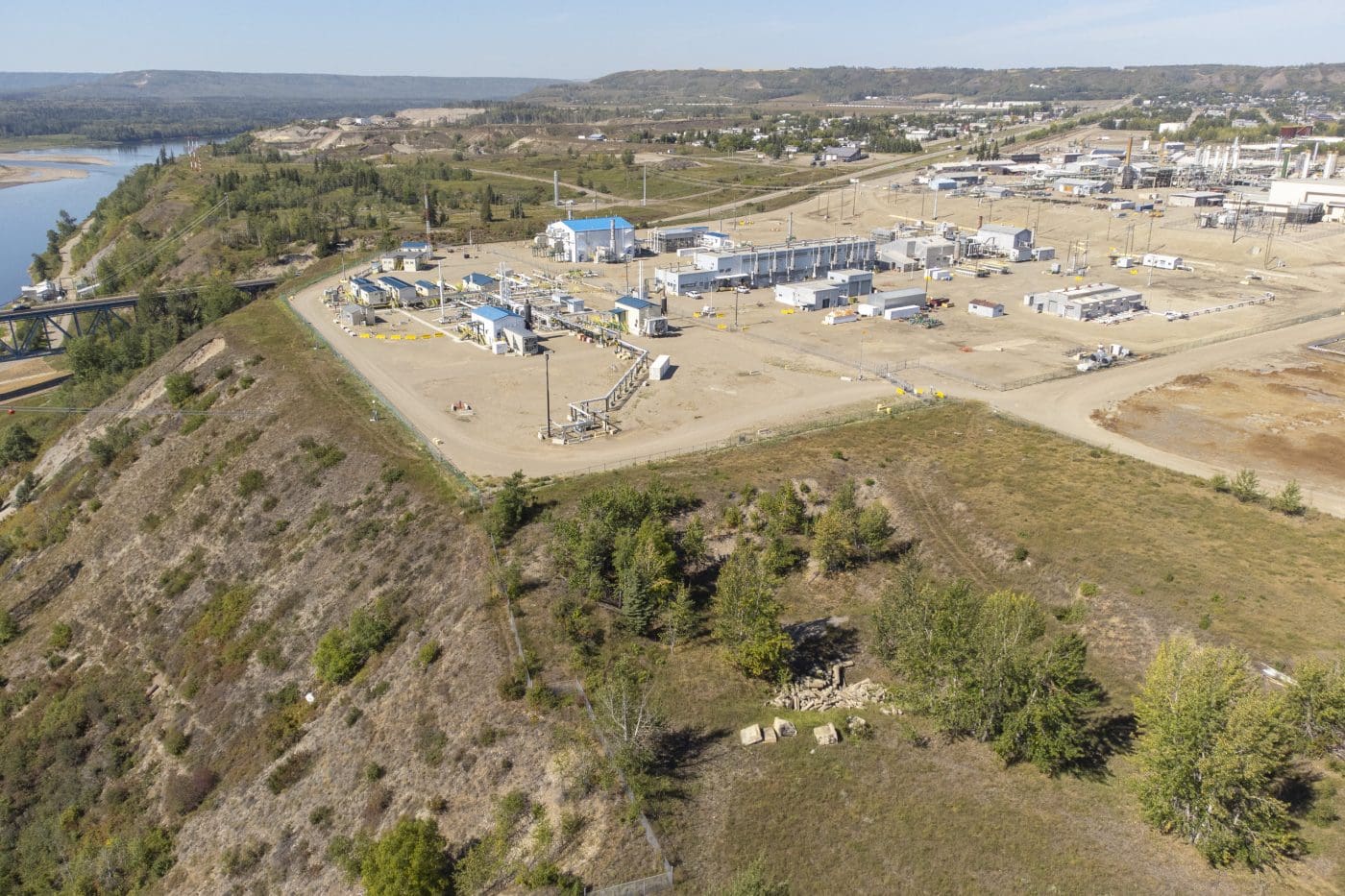 A power plant on the top of a hillside.