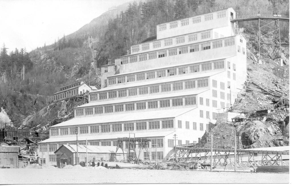 A black and white archival image of Mill No. 3 at the Britannia Beach copper mine. It is a structure several storeys tall build into the side of a hill.