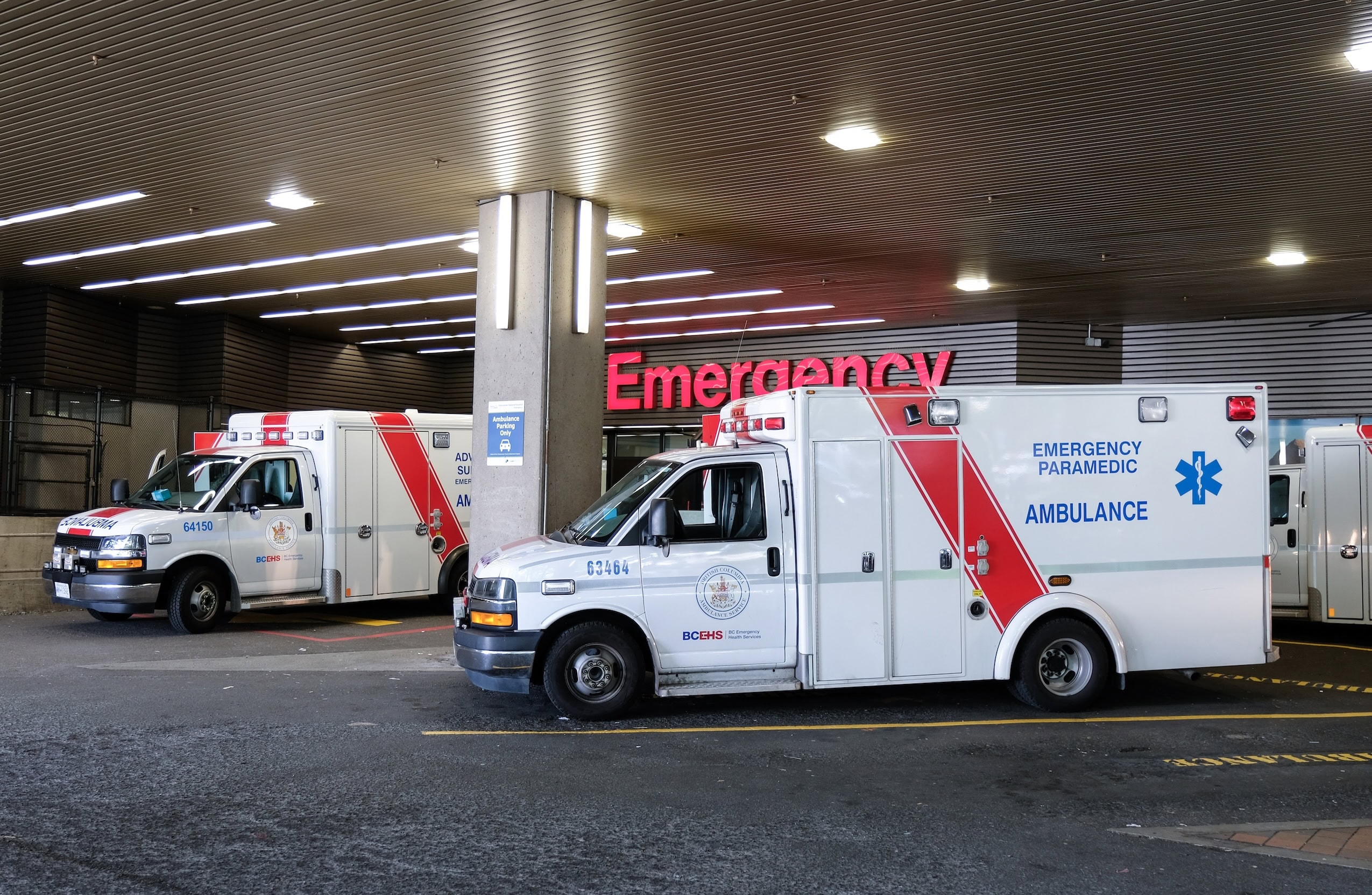 Two ambulances are parked outside of the emergency department of the Vancouver General Hospital.