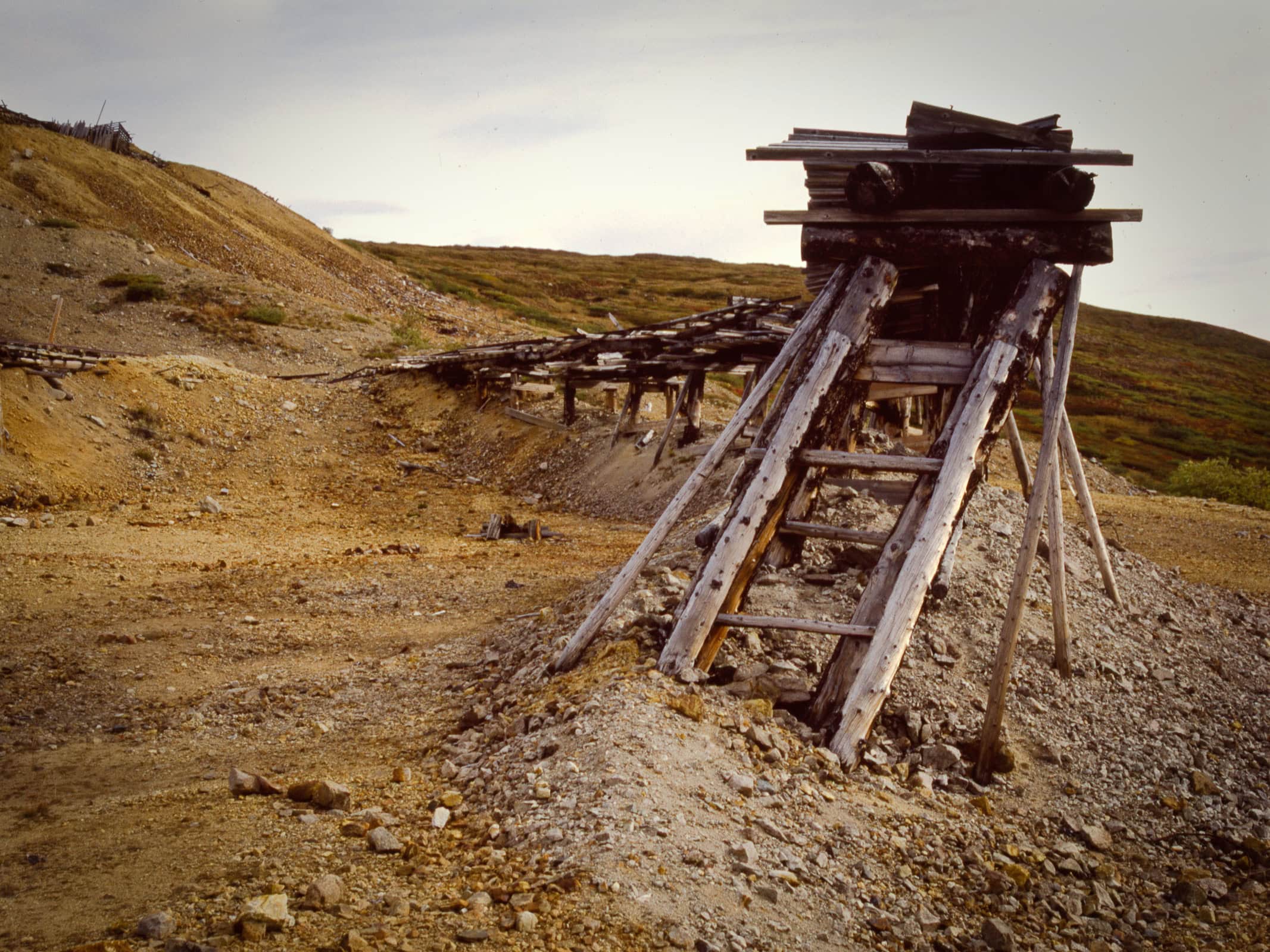 An abandoned mine apparatus on a low hillside.