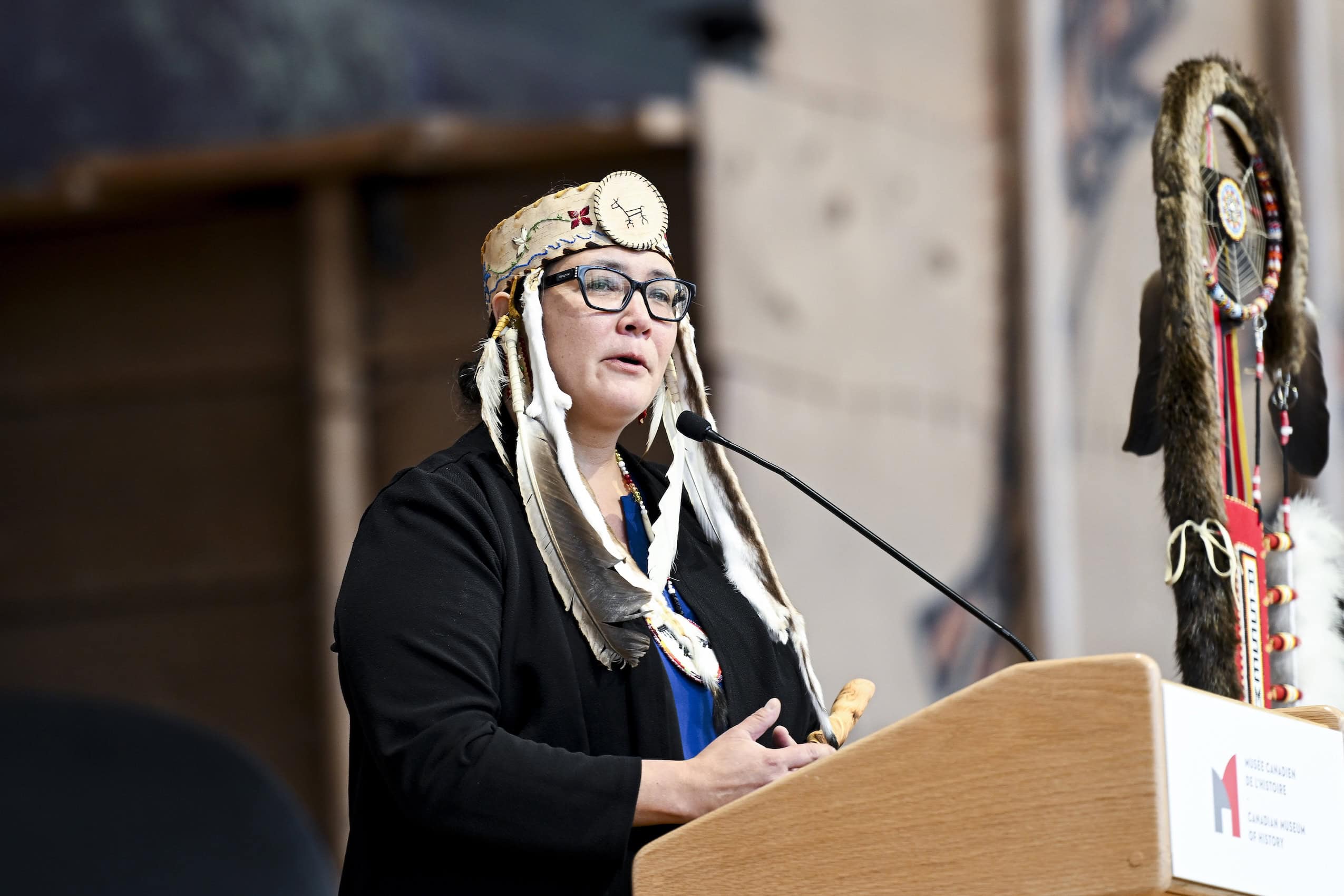 Anishinabek Nation Grand Chief Linda Debassige speaks at a press conference podium.