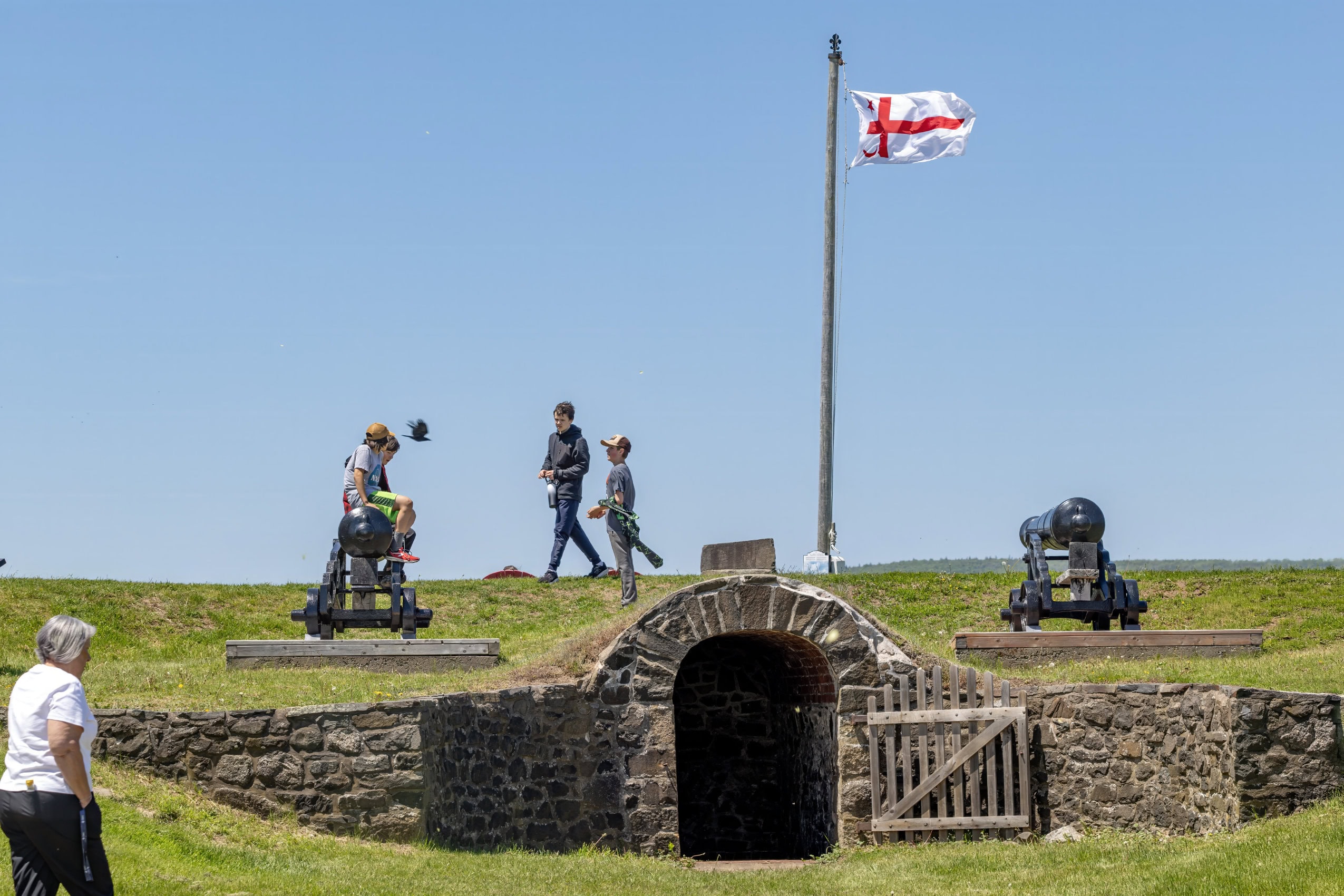 A Mi'kmaq flag stands out against a blue sky at Fort Anne in Annapolis Royal, Nova Scotia.