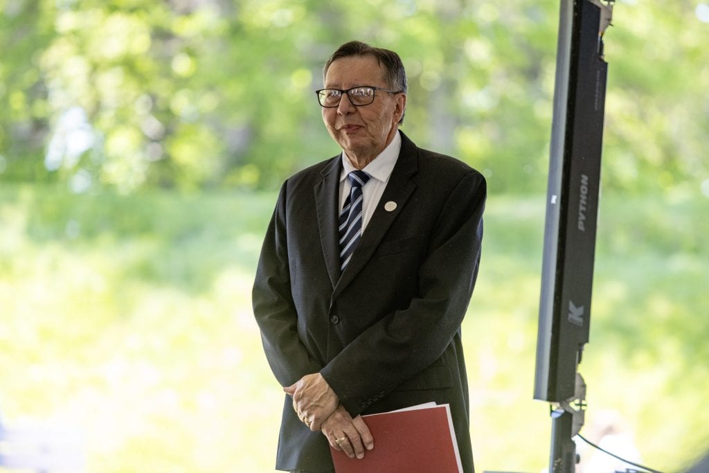 A man wearing a dark suit.