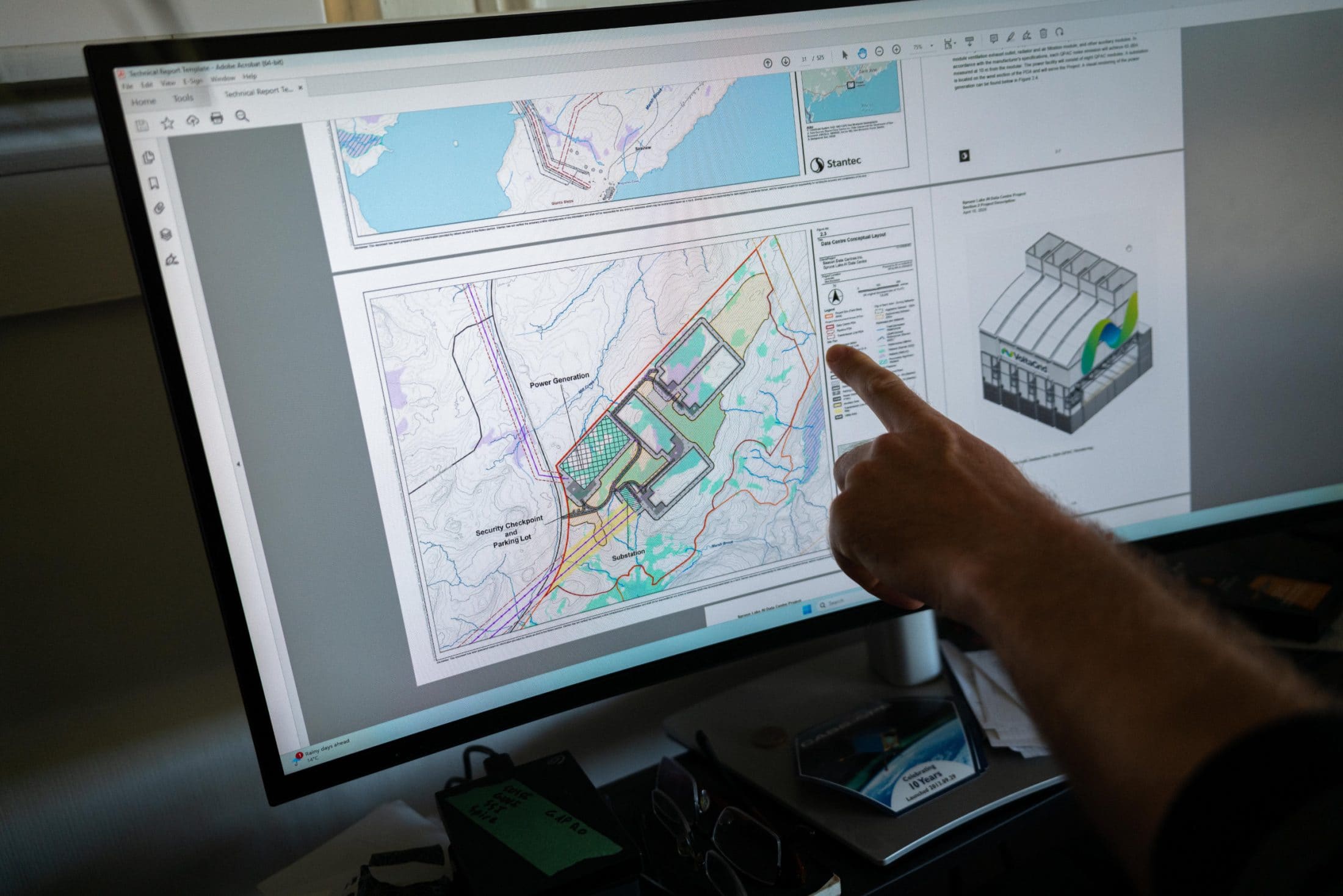 A finger points to computer monitor that is displaying a map of a proposed data centre site plan.