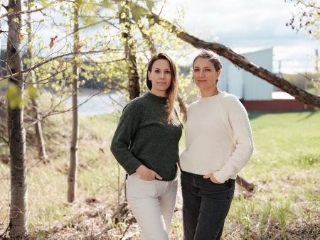 Carol Linnitt and Emma Gilchrist stand next to each other with a scenic, blurred out background.