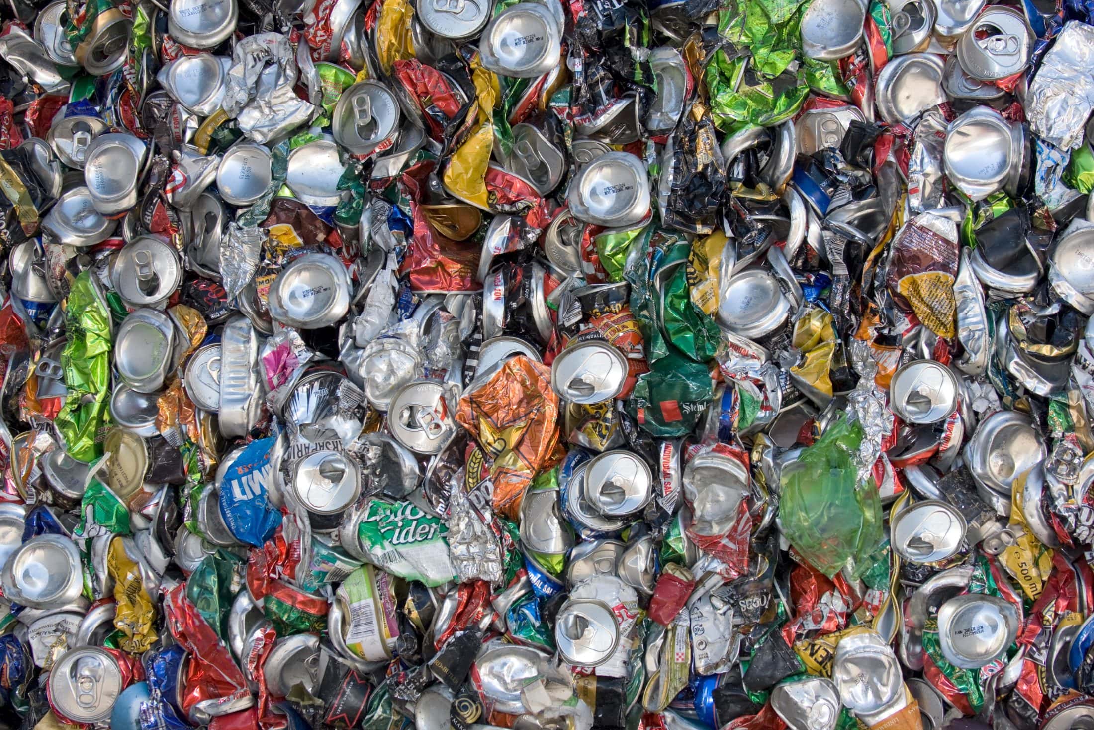 A close up of cans, plastic water bottles and other recycling