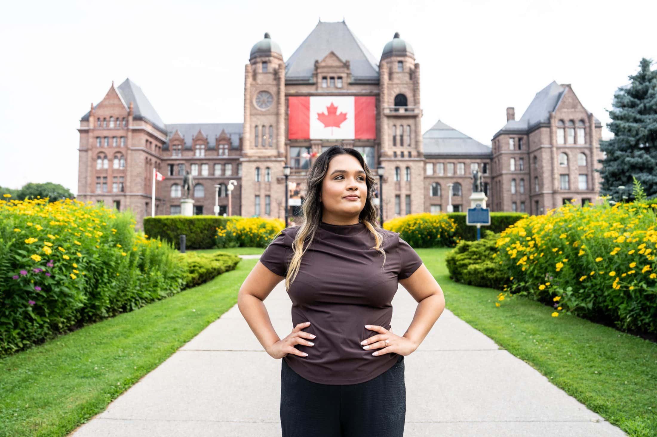 Reporter Rajpreet Sahota stands in front of Queen's Park in Toronto.