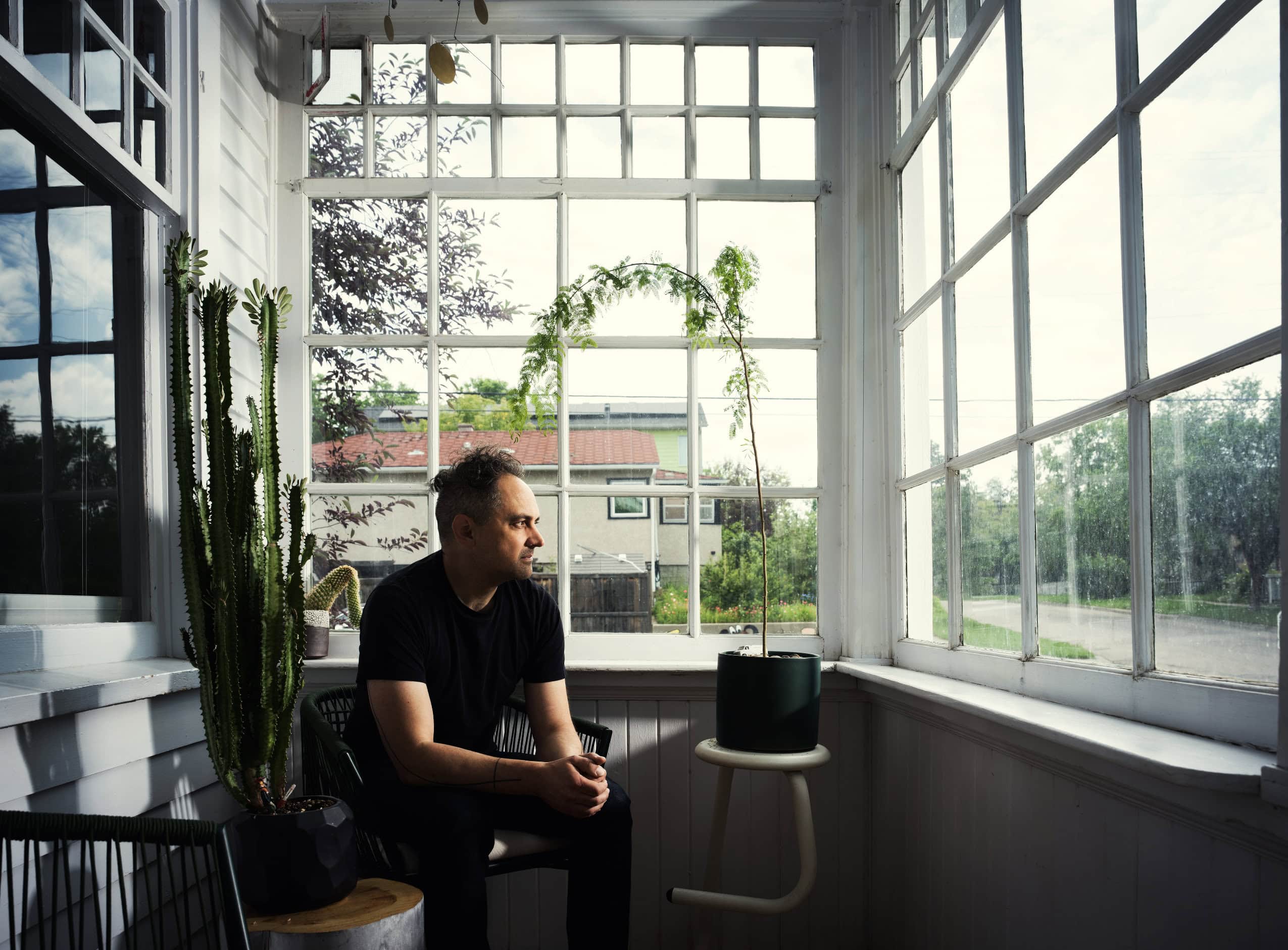 Jim Johansson sits on his house porch, gazing onto the street outside.