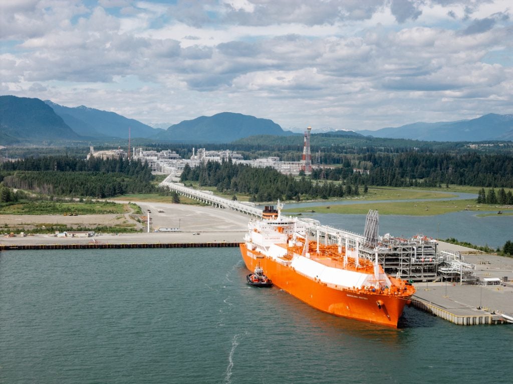 An orange tanker sits at a dock at the LNG facility in Kitimat, B.C