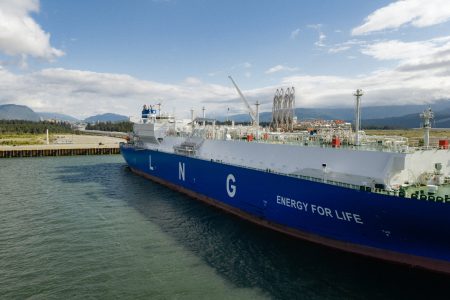 A blue tanker with the words LNG energy for life sits at a dock in Kitimat.