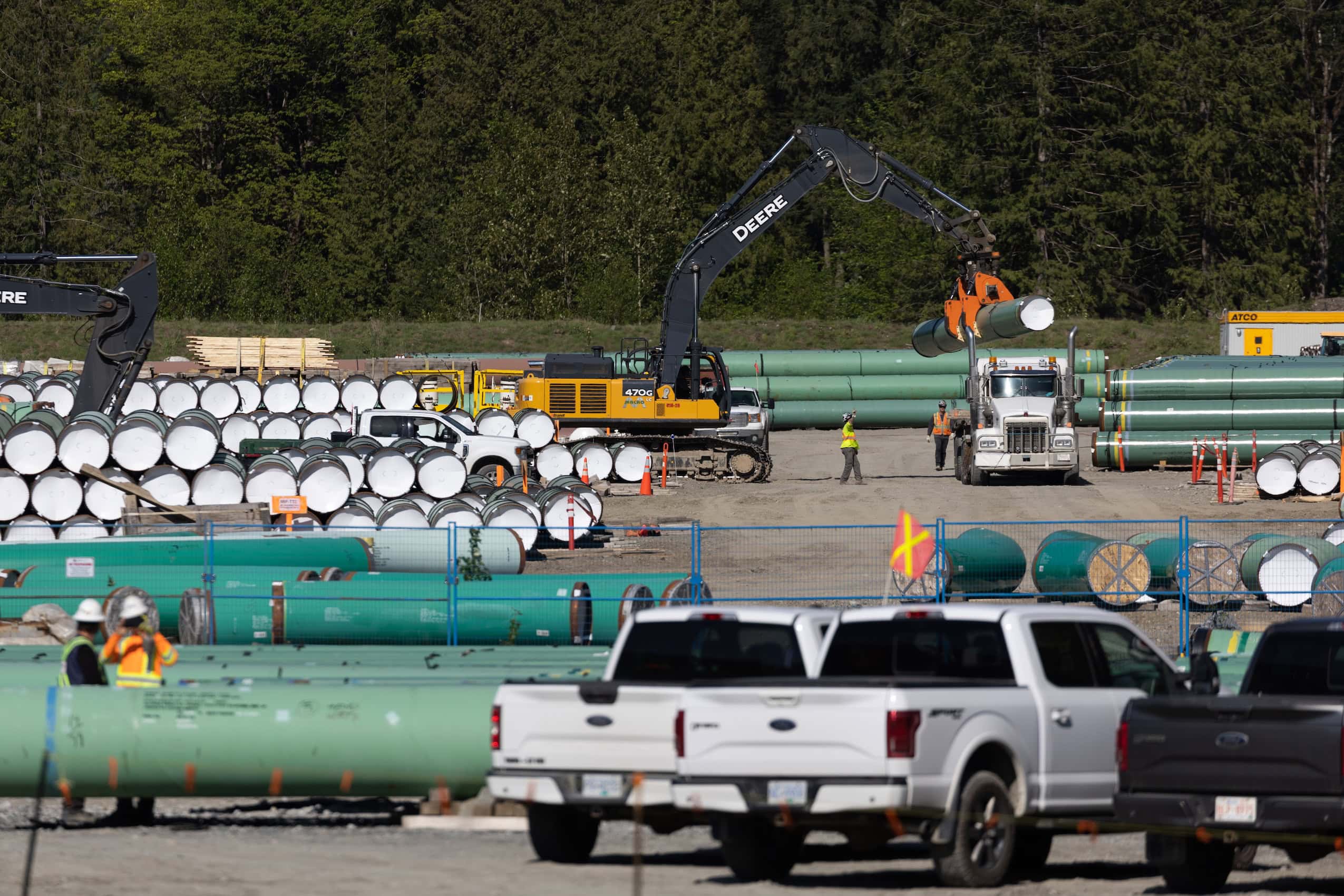 Pipeline components are stored at a construction site.