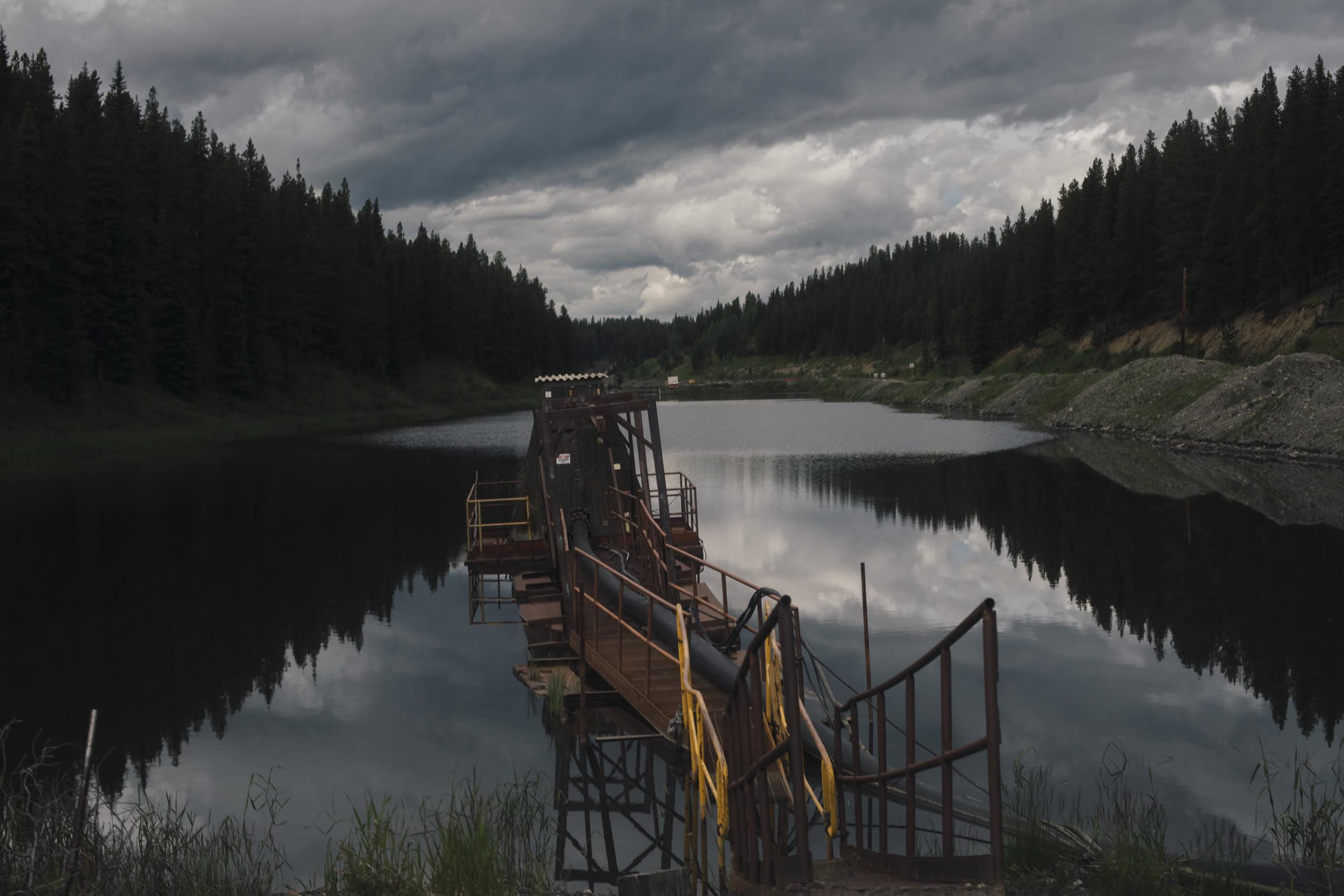 A pump on the edge of a mining sedimentation pond.