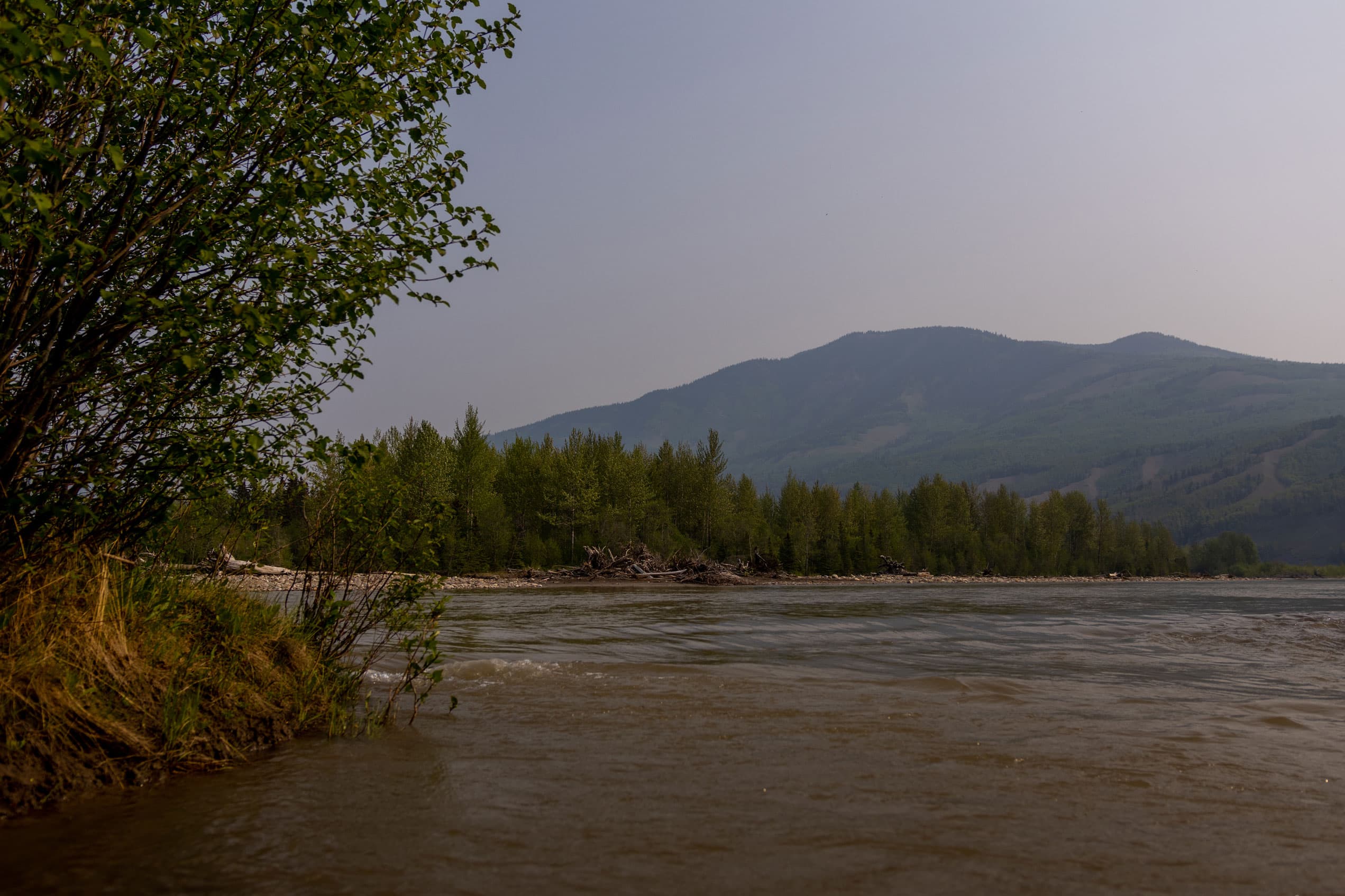 The Smoky River, with low mountainside behind it.