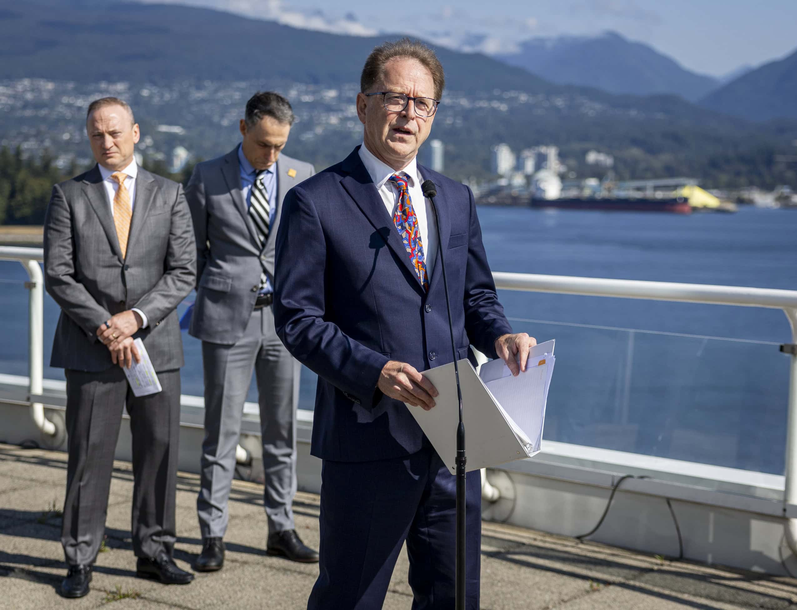 B.C. Energy Minister Adrian Dix speaks into a microphone during an announcement.