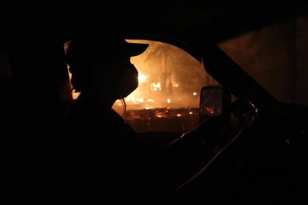 Photo of a B.C. volunteer firefighter fleeing a 2023 wildfire near Chase, B.C.