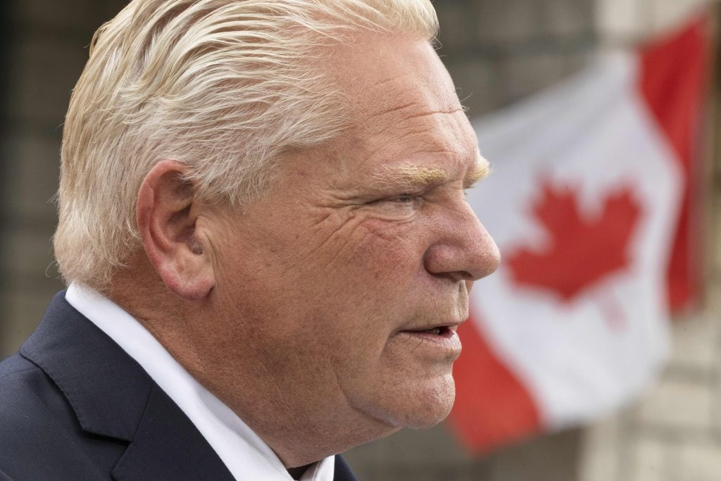 Doug Ford's face up close with a Canadian flag in the background