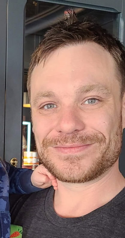 A headshot of Matthew Brackenreed.