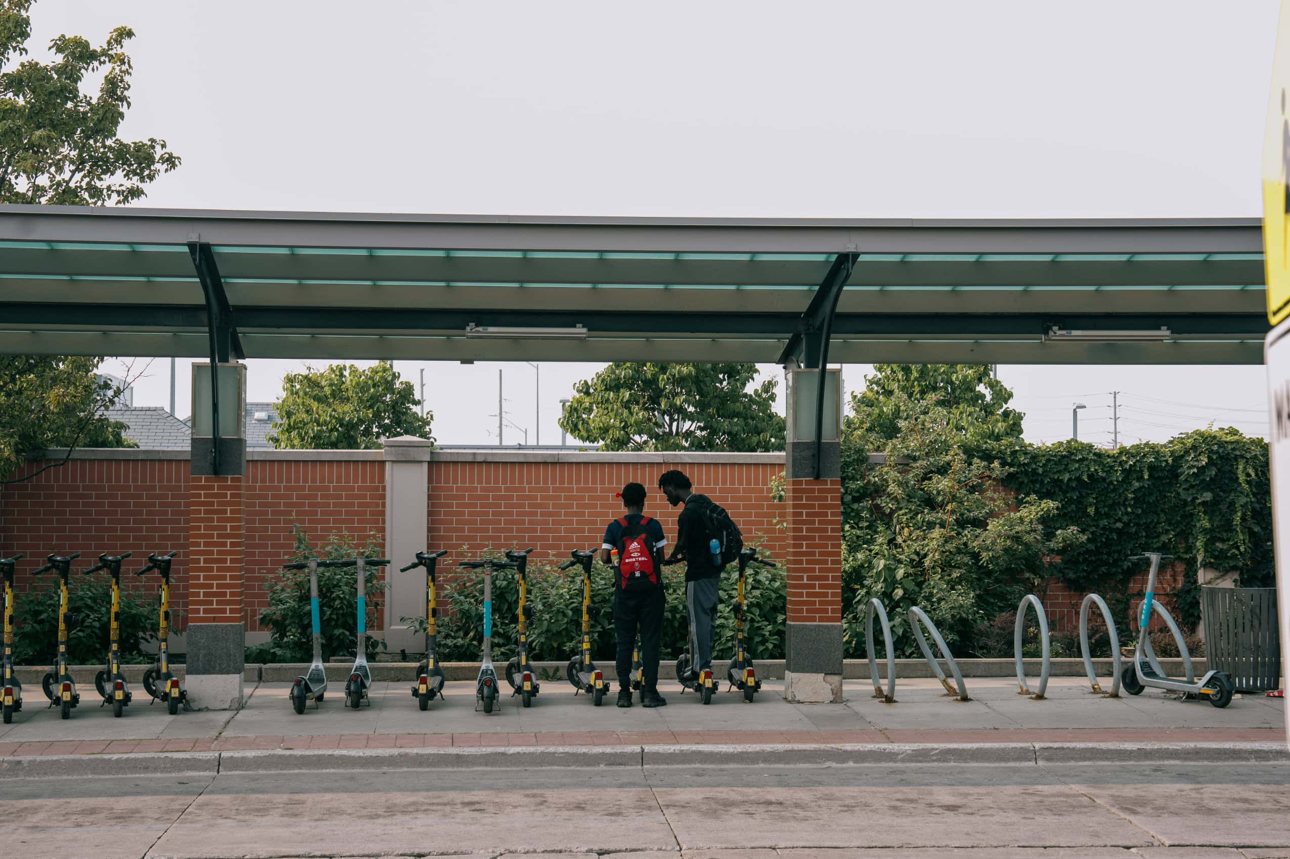 To riders retrieve scooters at the Mount Pleasant GO Station in Brampton, Ontario.