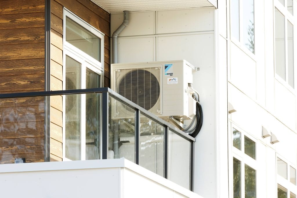 A heat pump installed on an apartment balcony