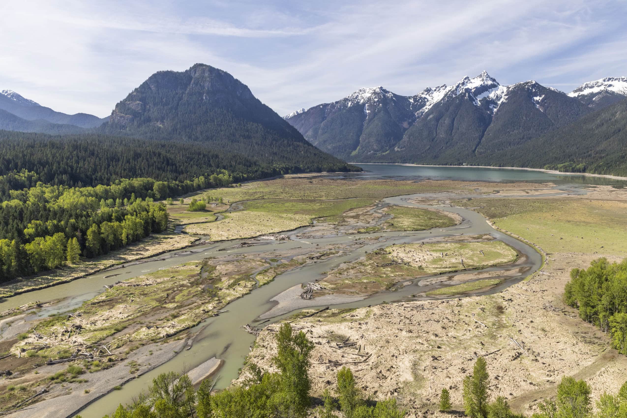 An aerial image of a river delta in a mountainous region.