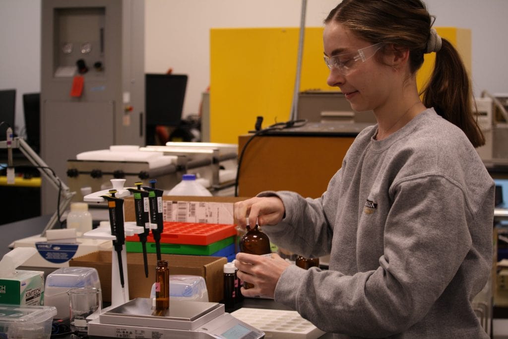 Researcher Angelina Jaeger works with water samples at a lab.