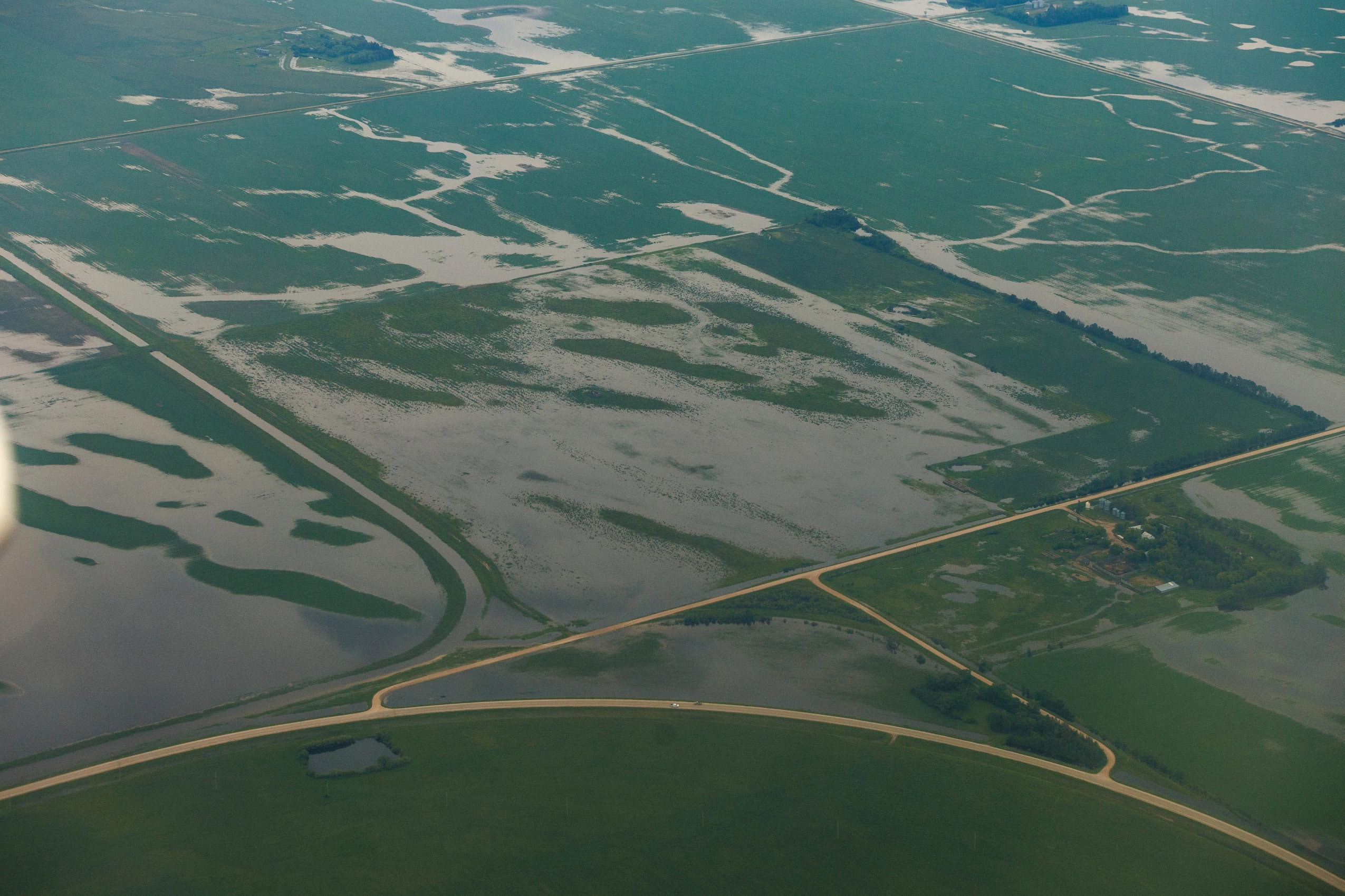 An aerial view of waterlogged farm fields after a heavy rain.
