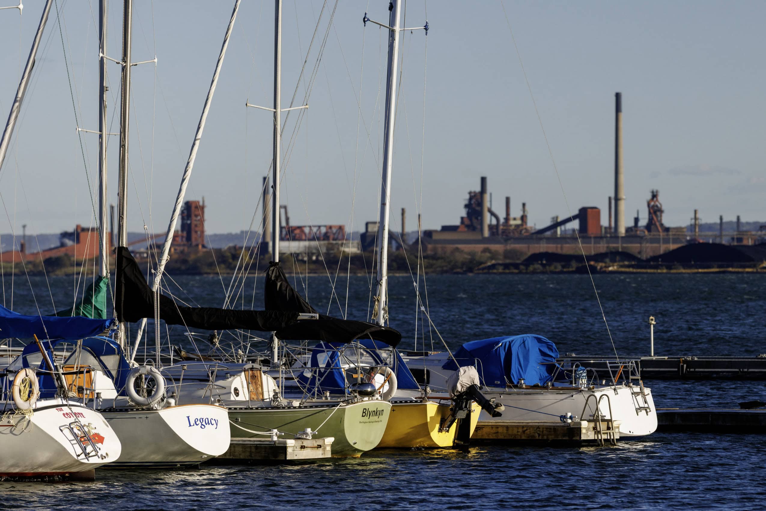 Sailboats docked at a marina in Burlington, Ont., with the ArcelorMittal Dofasco steel plant in the background, across the Hamilton Harbour.