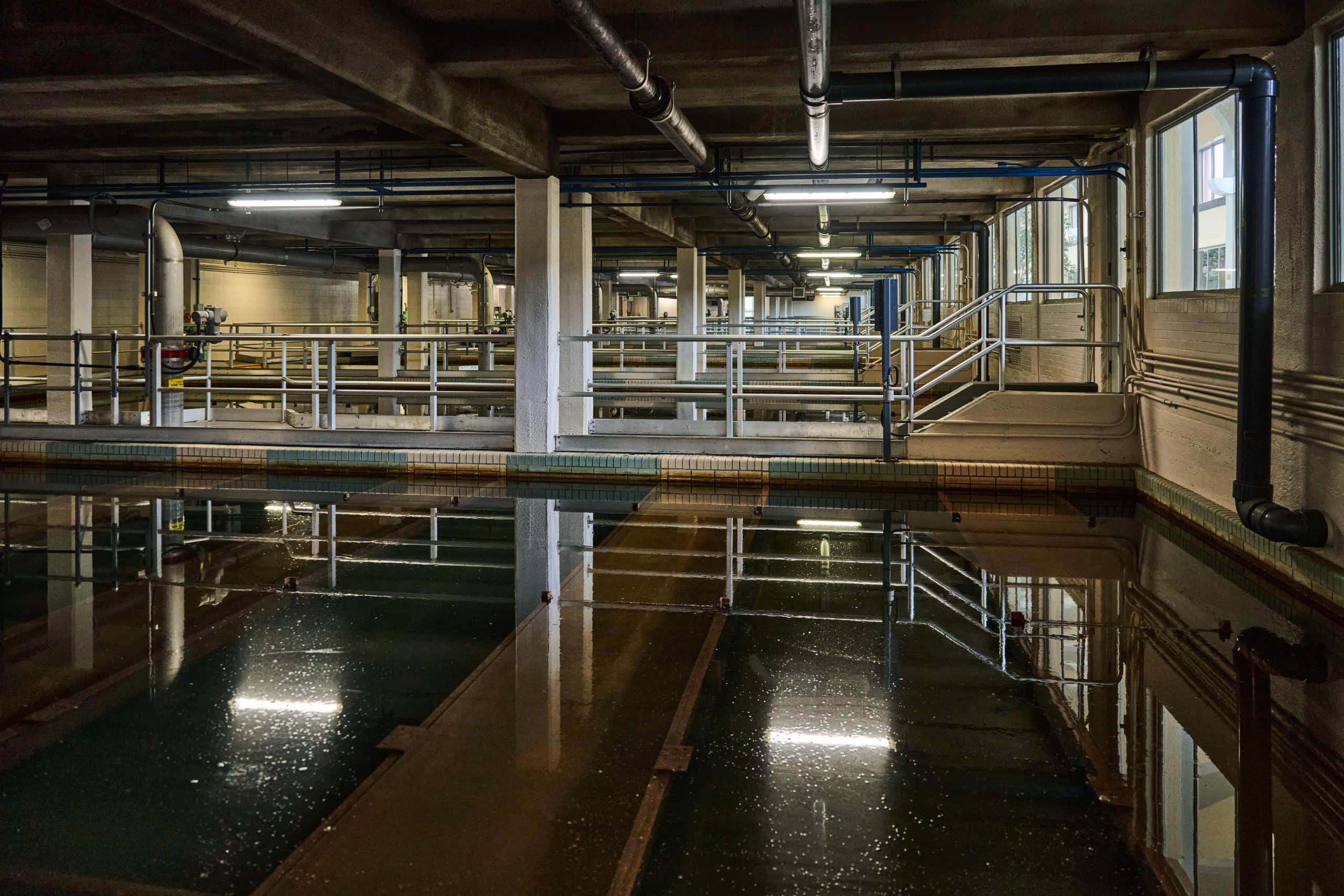 Cavernous room with water settling tanks.