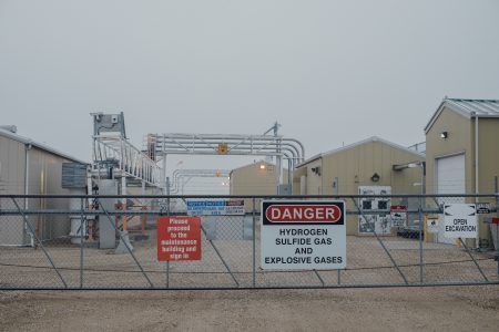 Danger signs on the fence of an industrial facility
