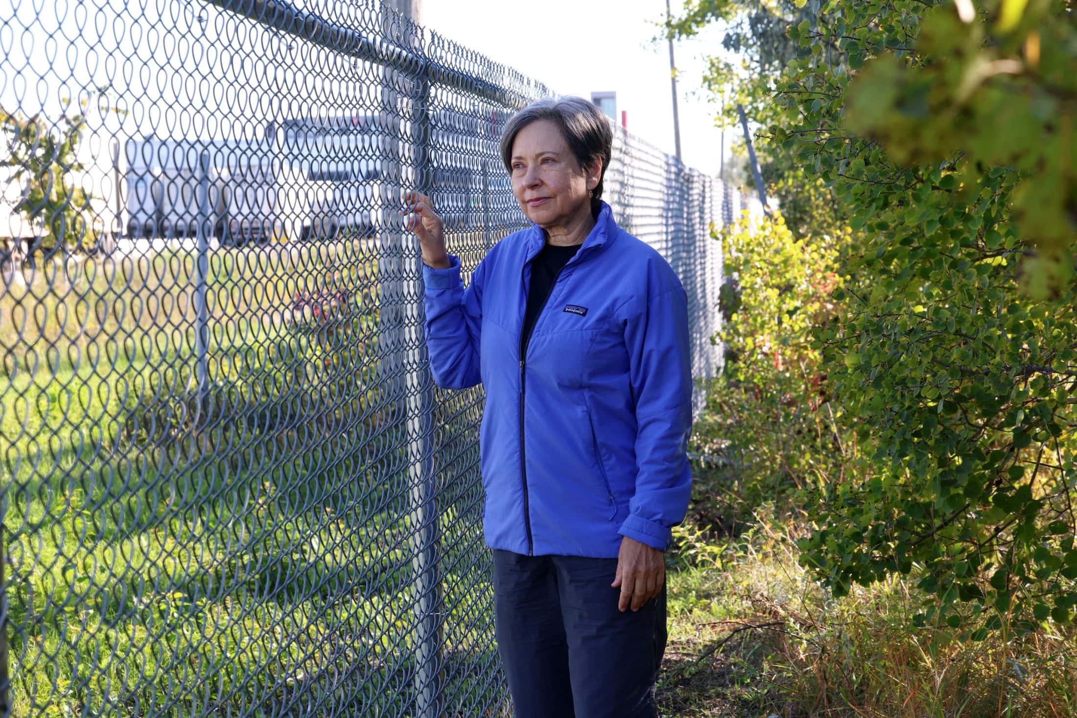Patricia Dutchak, chair of the Transcona Rotary Club’s parks committee, stands next to a chain link fence.