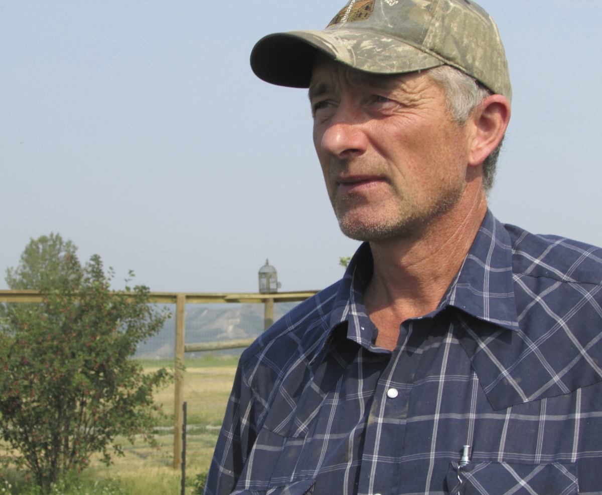 Ken Boon stands in his field in the Peace Valley